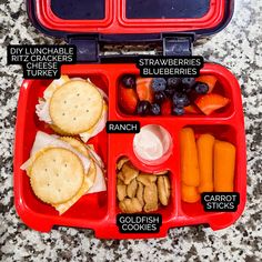 an open red lunch box filled with food and words describing the different foods in it