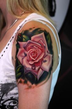 a woman with a rose tattoo on her arm