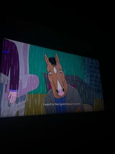 a television screen with a cartoon horse on it's face in the dark,