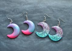 Dangle earrings with resin glitter moon and star pendants available in the foollowing options: 1. Pink/Purple/Blue Moons 2. Purple/Blue Glitter Moons Purple/Blue Glitter Moon & Star Purple/Blue Glitter Stars Please note that the colour distribution may vary slightly to the image shown. For other pastel items including the matching necklace click here: https://www.etsy.com/uk/shop/InfiniteRoseDesigns?ref=seller-platform-mcnav&section_id=23620397 For other celestial items in my shop click here:    https://www.etsy.com/uk/shop/InfiniteRoseDesigns?ref=seller-platform-mcnav&section_id=24328296 Thank you for visiting, for more items from InfiniteRoseDesigns, go to my shop: https://www.etsy.com/uk/shop/InfiniteRoseDesigns?ref=seller-platform-mcnav Handmade Moon-shaped Party Earrings, Handmade Moon Earrings For Party, Handmade Moon Shape Party Earrings, Kawaii Moon, Pet Artwork, Star Purple, Pastel Earrings, Earrings Kawaii, Pastel Kawaii