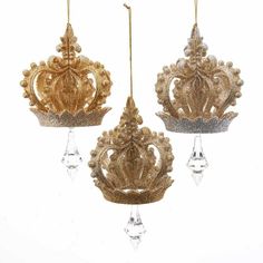 three gold and silver ornaments hanging from chains on a white background, one with crystal drops