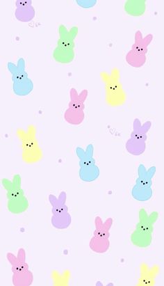 an iphone wallpaper with pastel colored bunny faces on it's back ground