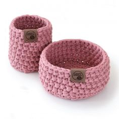 two pink knitted baskets sitting next to each other