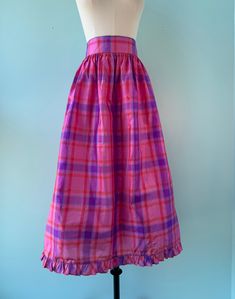 I love Bill Tice designs, they are easy to wear and beautiful to look at. This 80s Midi skirt is part of a holiday collection that he put out. The lightweight fabric is 100% silk, pink with purple plaid. wide waist band, ruffled hemline. One pocket. Hand finished and luxurious piece. Made in India. Excellent Vintage Condition. Pinned back on mannequin. Laid Flat: 14.25" Waist Open Hips 33" Long Pink Lined Skirt For Daywear, Relaxed Pink Skirt For Daywear, Pink Long Skirt For Daywear, Pink Ruffled Skirt For Daywear, Pink Lined Skirt Bottoms For Daywear, Pink Cotton Skirt For Daywear, Pink Skirted Bottoms For Daywear, Open Hips, 80s Skirt