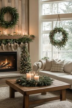 a living room decorated for christmas with wreaths and candles