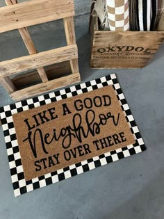 a door mat that says, like a good neighbor stay over there on the floor