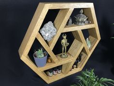 a wooden shelf filled with small figurines and plants