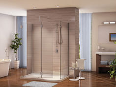 a bathroom with a stand up shower and wooden flooring, along with a white bathtub