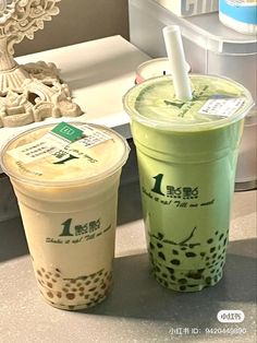 two iced drinks sitting next to each other on a counter