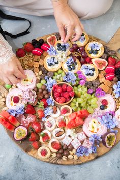 a platter filled with fruit and pastries on top of a table