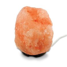 an orange rock with a white cord on it's end is shown in front of a white background