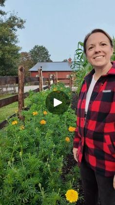 a woman standing in front of a garden