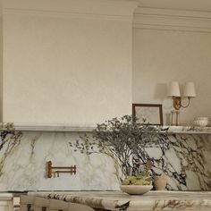 a kitchen with marble counter tops and an island in front of the stove top oven