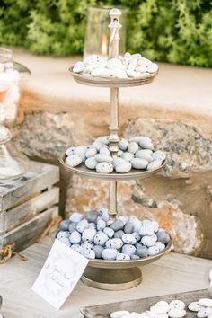 three tiered trays filled with blue and white candies