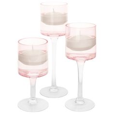 three empty wine glasses sitting next to each other