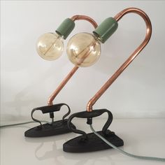 two light bulbs are connected to the same metal pipe and plugged into each other