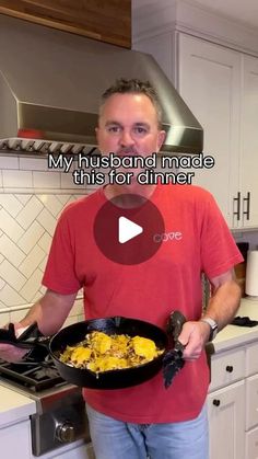 a man holding a skillet filled with food