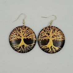 My earrings are made from maple wood and I paint them with iridescent acrylic paints.This pair of earrings has a tree design on it. The background wood is stained a dark brown and painted on top is a shimmery gold trunk with shimmery coppery leaves. The ear hooks and jump rings are made from gold plated surgical steel so you will not get any allergies!!!The approximate diameter of the wood is 4 cm / 1.5 inches. Artistic Hand Painted Brown Earrings, Handmade Wooden Gold Jewelry, Handmade Gold Wooden Jewelry, Iridescent Acrylic, Tree Design, Wood Earrings, Ear Hook, Tree Designs, Maple Wood