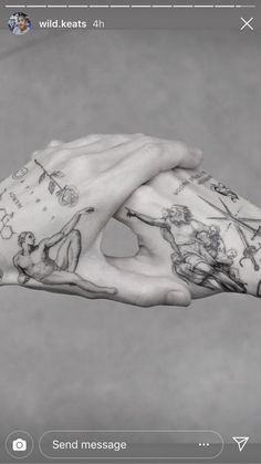 a person's hand with tattoos on it