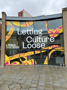 a building with a large window that says letting culture loose