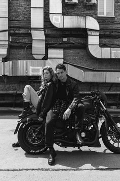 a man and woman sitting on a motorcycle