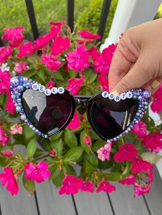 These sunglasses are unique, stylish and just the perfect gift! The heart-shaped design makes them so cute and trendy.  If you would like them customized just message me.  Possible options you might like: hello forty, fifty and fab, 21 and fun, newly 21, 30 and flirty, birthday queen, birthday babe, birthday gal, this is 40, 21 and thirsty, cheers to 21 years, etc. Check the images to see other possible sayings or you can always create your own.  Return Policy: As these sunglasses are customized products, we do not accept returns or exchanges unless there is a misspelling, we will send a corrected item at no additional charge. Bedazzled Sunglasses, Cheers To 21 Years, Hello Forty, Birthday Sunglasses, Diy Sunglasses, Personalized Sunglasses, Birthday Babe, Rhinestone Sunglasses, Queen Birthday