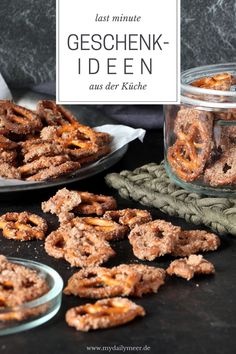 some pretzels are sitting on a table next to a glass jar with the words gescheink - iden