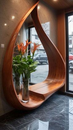 a vase filled with flowers sitting on top of a wooden shelf next to a window