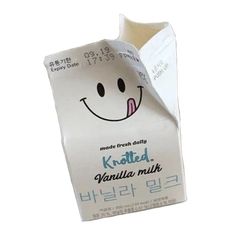 a white bag with a smiley face on it's side and the words kohled vanilla milk written in japanese