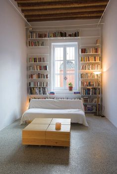 a living room filled with furniture and bookshelves