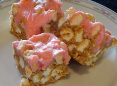 three pieces of cake on a plate with pink icing