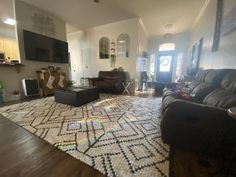 a living room filled with furniture and a flat screen tv