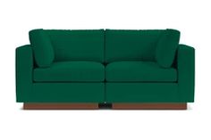 a green couch sitting on top of a white floor