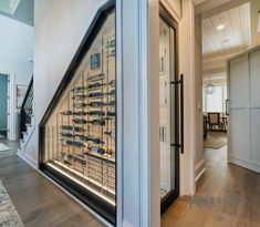 a large display case in the middle of a hallway with stairs leading up to it