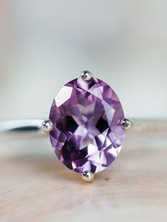 This classic compass style solitaire setting contains a beautiful 2.50ct. natural Rose De France amethyst. This unique setting has prongs in a north, south, east and west configuration. The oval cut stone measures approximately 9x7mm and the band is 2mm wide. The ring is available in sterling silver, and 14k white, yellow, or rose gold. This ring makes a unique promise or engagement ring. Please send me a message if you need a size not listed. * This ring can be customized with any color center Timeless Round Amethyst Ring, Timeless Oval Purple Amethyst Ring, Timeless Purple Oval Amethyst Ring, Classic Oval Amethyst Ring, Timeless Oval Amethyst Ring As Gift, Timeless Oval Amethyst Ring For Anniversary, Timeless Oval Amethyst Ring For Gift, Oval Amethyst Gemstone With Center Stone, Classic Lavender Amethyst Ring