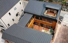 an aerial view of a modern house with wooden floors and large windows on the roof