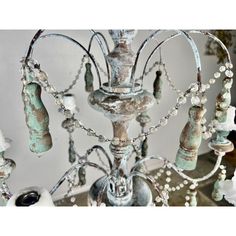 an old candelabra is adorned with glass beads