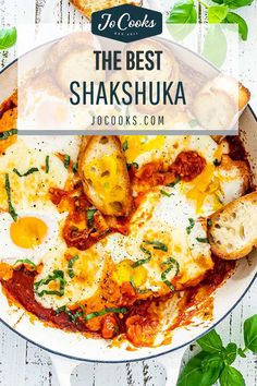 the best shakshuka recipe with eggs and cheese in a skillet on a white table