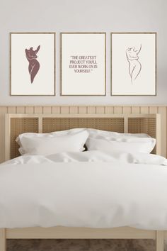 two framed art prints above a bed in a bedroom