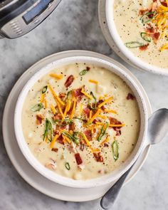 two bowls of soup with cheese and bacon