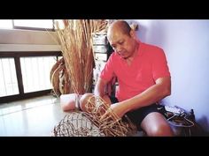 a man sitting on the floor working with wire