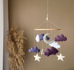 a mobile with clouds and stars hanging from it