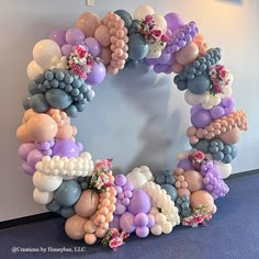 a wreath made out of balloons and flowers