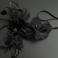 Masquerade mask in black. Simplistic for woman with a black floral- destined to pop out at any event, wedding etc This masquerade mask is great for any occasion.