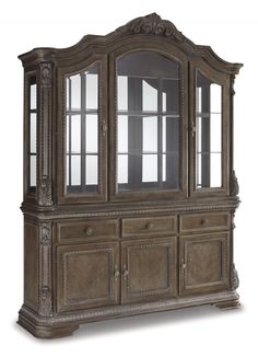 an antique china cabinet with glass doors and carvings on the front, in grey wood