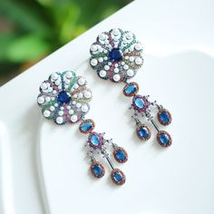 Kindly check out the Jhumka Kundan earrings section, where you can find more unique designs!  https://www.etsy.com/shop/VelvetVineEarrings?ref=seller-platform-mcnav&section_id=50758956 keywords: Jhumka Kundan earrings/statement floral dangles/wedding jewelry/cultural accessory/traditional anniversary/multi-stone handmade Christmas  👄Item details:  Originally designed by me and crafted in our Denver, Colorado studio, our family business thrives with the invaluable contributions of my brother and cousin, who play key roles in creating our items and maintaining our Etsy shop. Specifications: *Length:50mm *Width: 35mm *Materials: Stainless steel, vibrant quartz stones, handmade settings, featuring original vintage Kundan Jhumka designs.  Shipping: *Ships within 7 days from Denver, with free d Jhumka Designs, Kundan Earrings, Christmas Items, Earrings Statement, Denver Colorado, Multi Stone, Family Business, Quartz Stone, Handmade Christmas