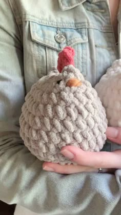 two crocheted turkeys are held in their hands