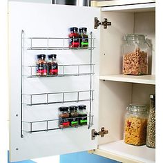 the pantry door is open to reveal shelves with food in jars and cereal on them