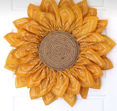 a sunflower made out of jute and burlock on a white door