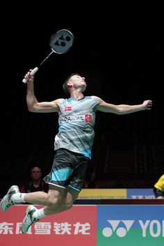 a man jumping in the air with a tennis racket